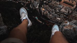 Preview wallpaper legs, sneakers, city, aerial view, coast