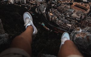 Preview wallpaper legs, sneakers, city, aerial view, coast