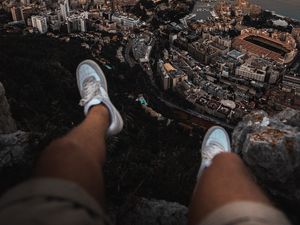 Preview wallpaper legs, sneakers, city, aerial view, coast