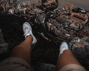 Preview wallpaper legs, sneakers, city, aerial view, coast