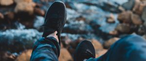 Preview wallpaper legs, sneakers, coast, stones, mountains