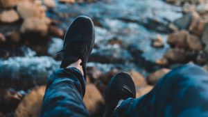 Preview wallpaper legs, sneakers, coast, stones, mountains