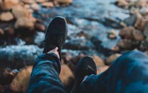 Preview wallpaper legs, sneakers, coast, stones, mountains