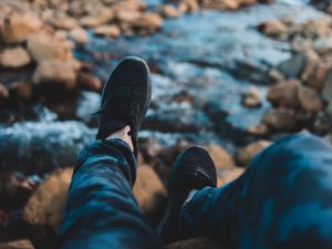 Preview wallpaper legs, sneakers, coast, stones, mountains