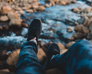 Preview wallpaper legs, sneakers, coast, stones, mountains