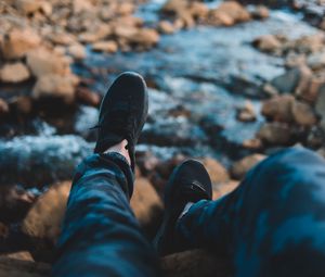 Preview wallpaper legs, sneakers, coast, stones, mountains
