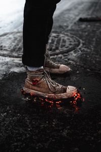 Preview wallpaper legs, sneakers, fire, asphalt, snow