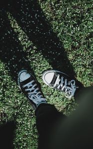 Preview wallpaper legs, sneakers, grass, flowers