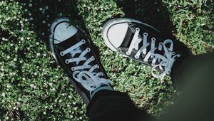 Preview wallpaper legs, sneakers, grass, flowers