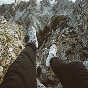 Preview wallpaper legs, sneakers, mountains