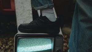 Preview wallpaper legs, sneakers, screen, tv, jeans