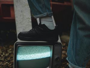 Preview wallpaper legs, sneakers, screen, tv, jeans