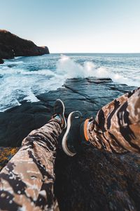 Preview wallpaper legs, waves, sneakers, rocks