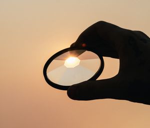 Preview wallpaper lens, hand, shine, silhouette, sunset