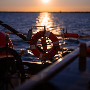 Preview wallpaper lifebuoy, sea, sunset, blur