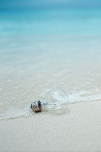 Preview wallpaper light bulb, beach, water, waves, sand