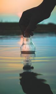 Preview wallpaper light bulb, hand, water, wet, waves