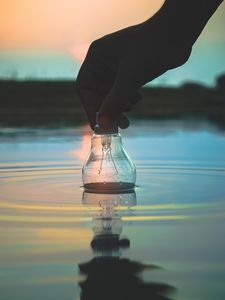 Preview wallpaper light bulb, hand, water, wet, waves