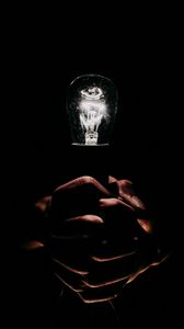Preview wallpaper light bulb, hands, fingers, light, electric, dark