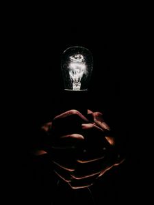 Preview wallpaper light bulb, hands, fingers, light, electric, dark