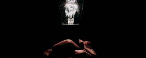 Preview wallpaper light bulb, hands, fingers, light, electric, dark