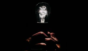 Preview wallpaper light bulb, hands, fingers, light, electric, dark