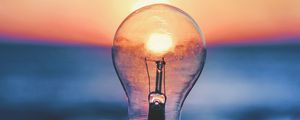 Preview wallpaper light bulb, sunset, sun, focus