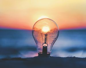 Preview wallpaper light bulb, sunset, sun, focus
