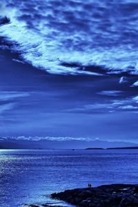 Preview wallpaper light, sky, beams, clouds, from above, dark blue, evening, sea, people
