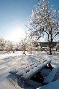Preview wallpaper light, sun, winter, table, benches, snowdrifts, snow, cover, park, sky, clearly