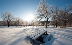 Preview wallpaper light, sun, winter, table, benches, snowdrifts, snow, cover, park, sky, clearly