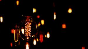 Preview wallpaper lightbulb, electricity, dark, spiral, bokeh
