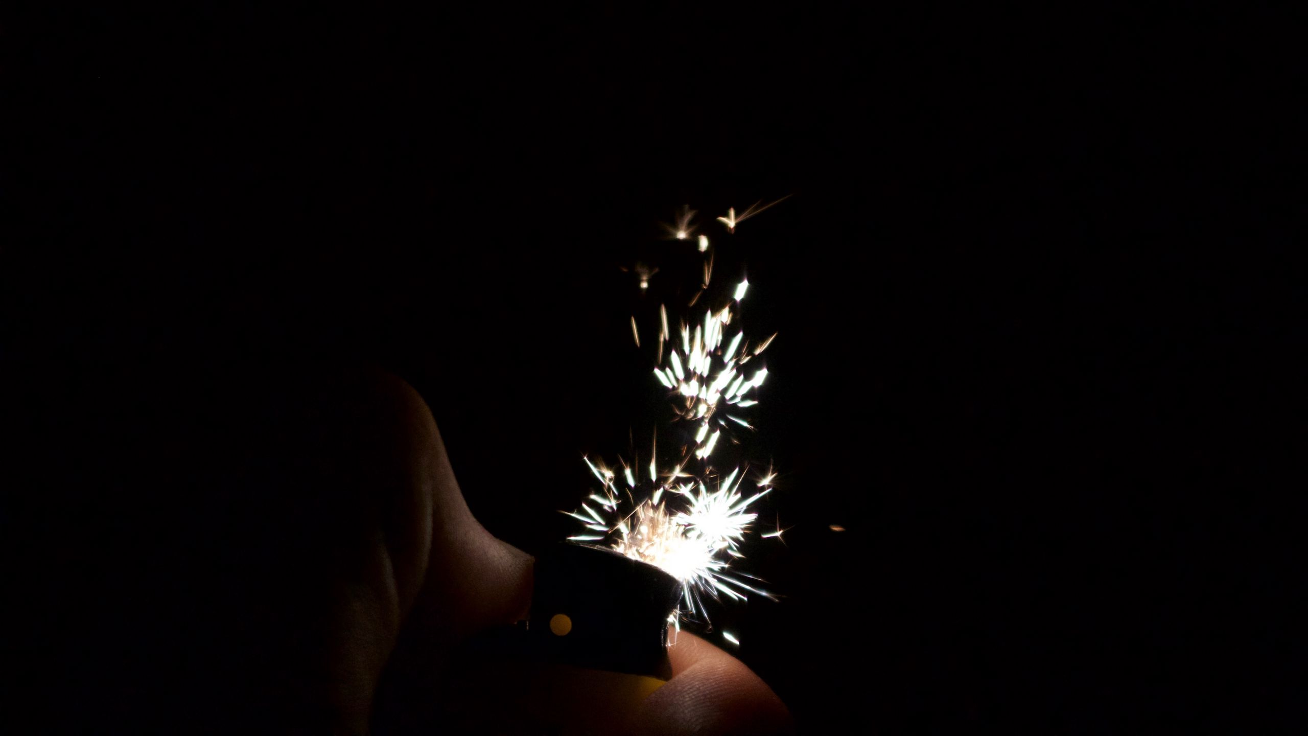 Download wallpaper 2560x1440 lighter, sparks, dark widescreen 16:9 hd