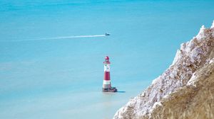 Preview wallpaper lighthouse, building, boat, sea, grass, horizon