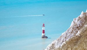 Preview wallpaper lighthouse, building, boat, sea, grass, horizon