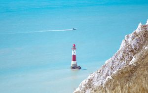 Preview wallpaper lighthouse, building, boat, sea, grass, horizon