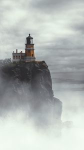 Preview wallpaper lighthouse, building, cliff, rock, fog