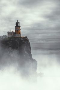 Preview wallpaper lighthouse, building, cliff, rock, fog