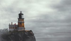 Preview wallpaper lighthouse, building, cliff, rock, fog