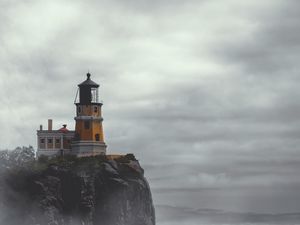 Preview wallpaper lighthouse, building, cliff, rock, fog
