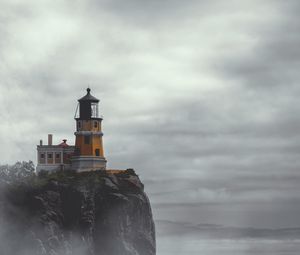 Preview wallpaper lighthouse, building, cliff, rock, fog