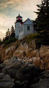 Preview wallpaper lighthouse, building, cliffs, sea, dusk