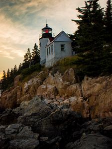 Preview wallpaper lighthouse, building, cliffs, sea, dusk