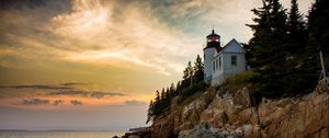 Preview wallpaper lighthouse, building, cliffs, sea, dusk