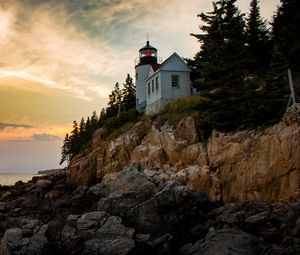 Preview wallpaper lighthouse, building, cliffs, sea, dusk