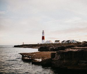 Preview wallpaper lighthouse, building, coast, sea, horizon, water