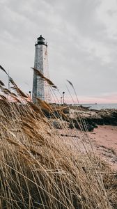 Preview wallpaper lighthouse, building, grass, coast, sea