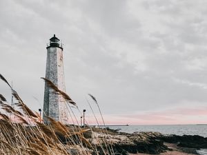Preview wallpaper lighthouse, building, grass, coast, sea
