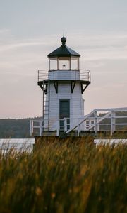 Preview wallpaper lighthouse, building, grass, coast, sea, trees