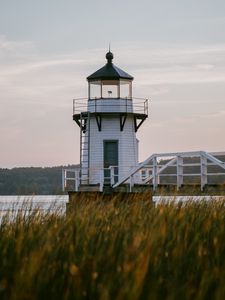 Preview wallpaper lighthouse, building, grass, coast, sea, trees